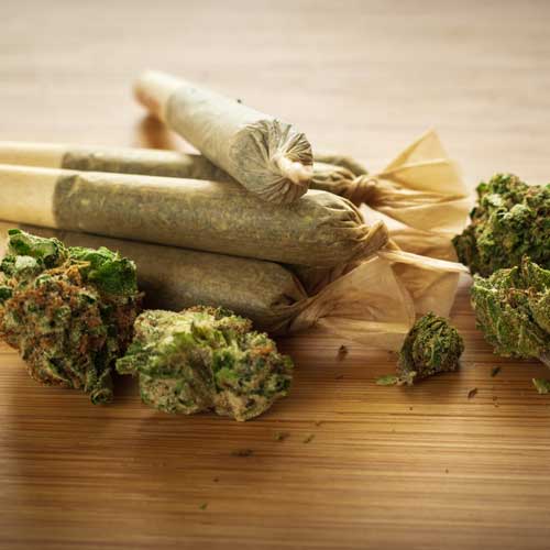 pre-rolled cannabis blunts on a wooden table